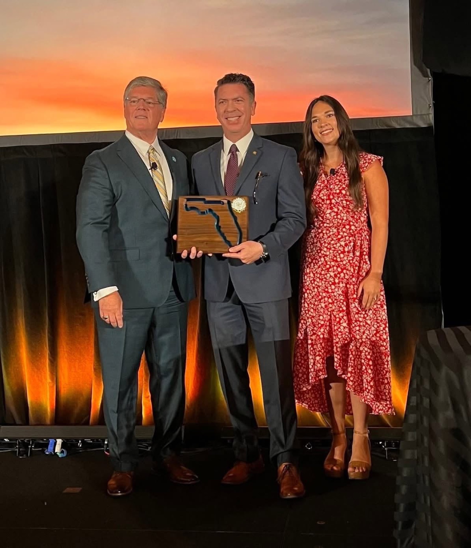 Representative Ryan Chamberlin accepting the 2025 Legislator of the Year award on stage